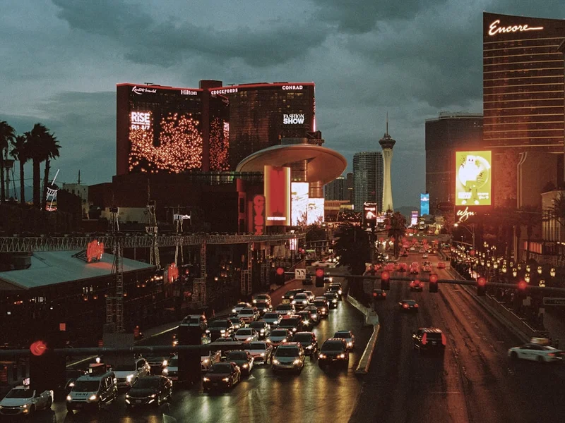 Busy las vegas street with traffic at dusk.